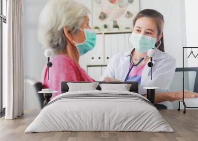 Asian Old Patient woman  checking heart with Medical Doctor women in clinic office hospital Wall mural