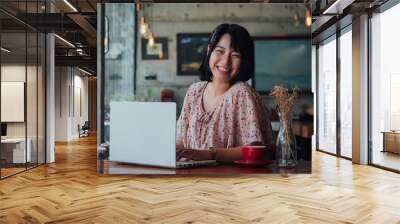 Asian woman drinking coffee and relax in coffee shop cafe Wall mural