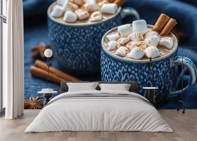 Two cups of hot chocolate with marshmallows and cinnamon sticks on a dark blue tablecloth, top view, flat lay background, minimal concept Wall mural