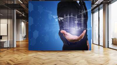 Businessman's hand with building construction design reality virtual technology. Building automation digital wireless control concept. Wall mural