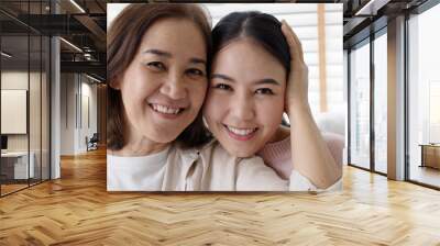 Close up attractive beautiful two asia people face cheek smile to camera authentic real family mum and adult kid in woman power day, diverse ethnic people, genes genetics ginger mom skincare concept. Wall mural