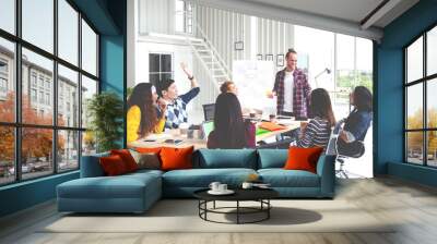 Group of young attractive asian creative design team meeting,smiling and laughing at office workshop. Asian employee engaged together with effective and productive meeting and happy workplace concept. Wall mural