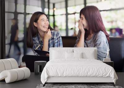 Two asian woman talking and discussion about work at coffee shop. Two asian teenage student college feeling funny and happy lifestyle. Wall mural