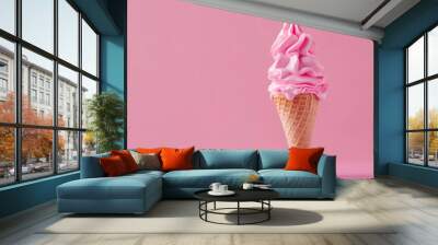 A pink ice cream cone is sitting on a pink background Wall mural