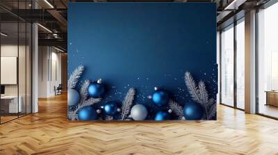 Christmas border composition with blue and silver ornaments and frosted fir branches on a classic blue background Wall mural