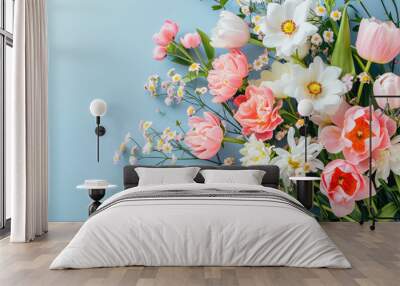 Bouquet of beautiful spring flowers on pastel blue table top view Wall mural