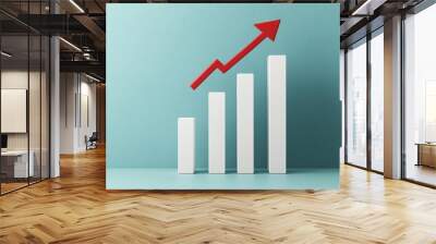 Business growth graph with a red arrow pointing up, white bars increasing in height, light blue backdrop, modern financial success concept Wall mural