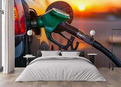 Car refueling at a gas station, with a focus on the fuel nozzle in action against a glowing sunset backdrop Wall mural