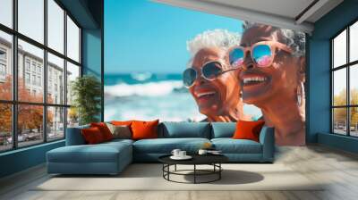 Active grandmothers relax on the beach. A couple of old lesbians. Two elderly women in sunglasses are smiling on the beach. They enjoy the sun Wall mural