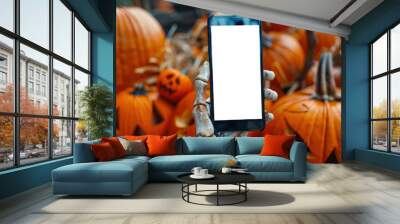 Halloween ads. A mockup of the phone. The skeleton holds a cell phone in his hand in front of a pile of pumpkins. The action takes place in a Halloween themed setting Wall mural