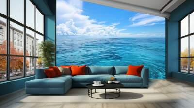 A beautiful scene of the blue ocean against the blue sky background. The ocean stretches out as far as the eye can see, with its surface glistening in the sunlight Wall mural