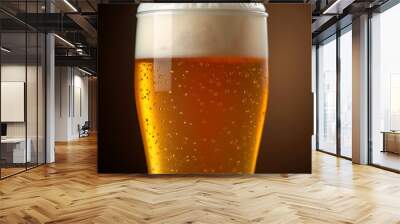 a full glass of beer with bubbles on the top. Wall mural