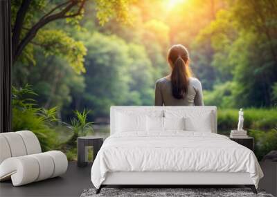 young lady sitting meditating behind nature  emerging daylight calm natural light outdoor peaceful Wall mural