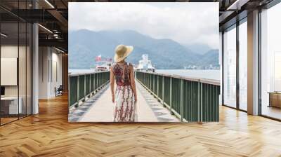 traveling Asian woman with hat Wall mural