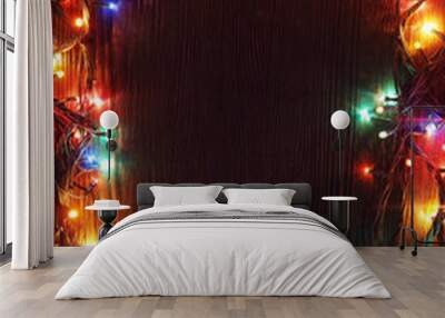 Christmas garlands of lamps on a wooden background. Wall mural