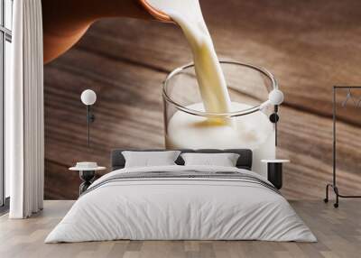 jug of milk with an old country table, a white drink is poured into a glass Wall mural