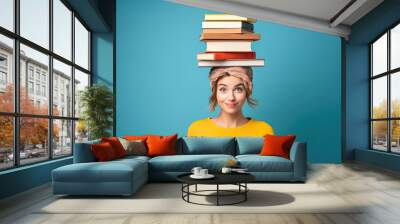 A cute smiling woman with a stack of books on the head Wall mural