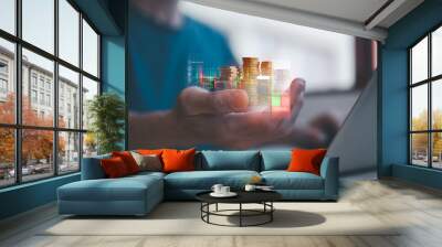 investment and finance concept, businessman holding virtual trading graph and blurred coins on hand, stock market, profits and business growth. Wall mural