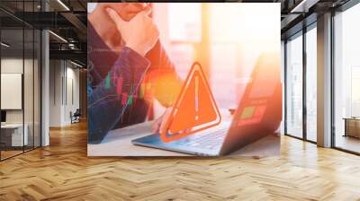 risk warning alert in financial and investment down trend economic global crisis concept Businessman using computer working with triangle sign analysis trading stock price chart Wall mural