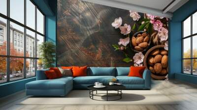 Almond tree, leaves and flowers on a wooden background. Delicious nuts, a healthy snack. Wall mural