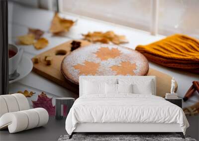 Beautiful fresh sweet pumpkin cake with a maple leaf pattern on a white wooden background Wall mural