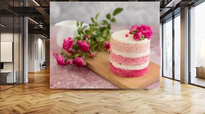 Beautiful pink cream and berries cake on a light concrete background. Birthday celebration Wall mural