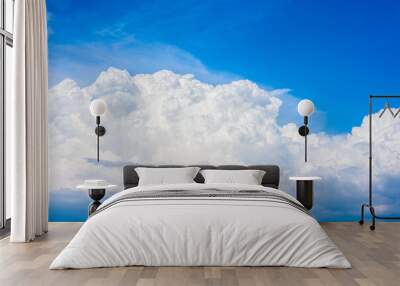 Beautiful white clouds in a bright blue sky on a warm summer day Wall mural