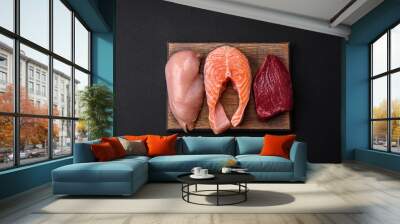 Chicken or turkey fillet, raw beef steak and salmon steak with spices and herbs Wall mural