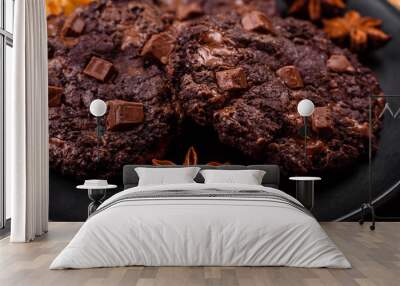 Delicious fresh oatmeal round cookies with chocolate on a black ceramic plate Wall mural