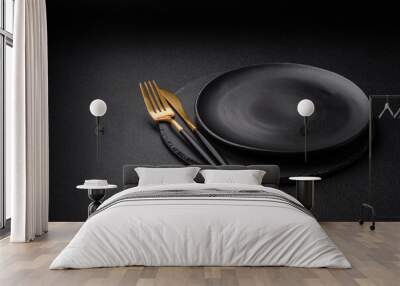 Empty black plate over dark stone background with copy space Wall mural