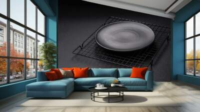 Empty ceramic round plate on dark textured concrete background Wall mural