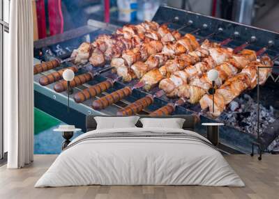 Marinated shashlik preparing on a barbecue grill over charcoal (skewered meat). Wall mural