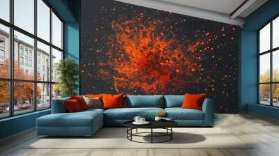 Vibrant abstract explosion of bright orange paint splatter on dark background Wall mural