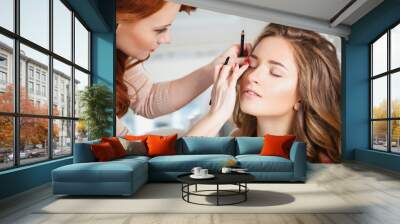 makeup artist preparing bride before the wedding in a morning Wall mural