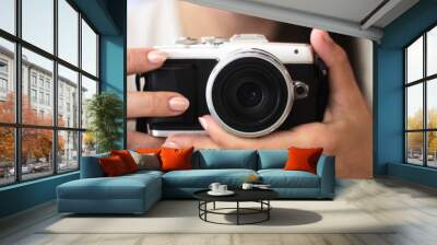 Young woman holds a compact photo camera Wall mural