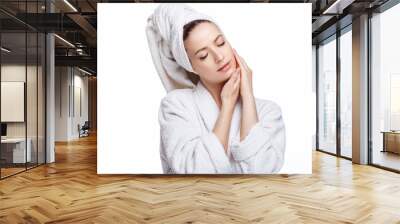 Young woman in a bathrobe and towel on her head, spa and care portrait, clean natural face, portrait on a white background isolated Wall mural