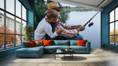 boy with his grandfather fishing on the lake Wall mural