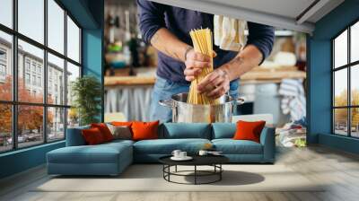 close up of man preparing pasta at home Wall mural