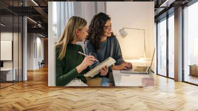 college students female friends using laptop in room Wall mural