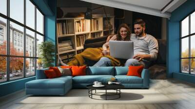 couple using laptop at home Wall mural