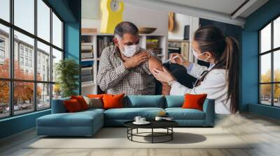 doctor gives corona virus vaccine, home care service concept Wall mural