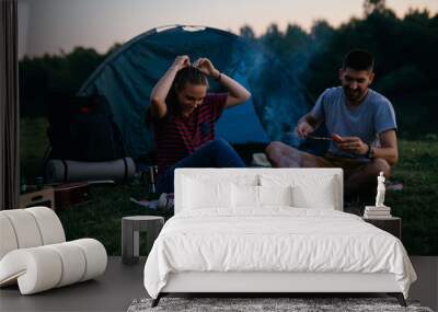 friends barbecue sausages on night camping outdoors Wall mural