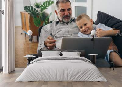 grandfather and his grandson using computer at home Wall mural