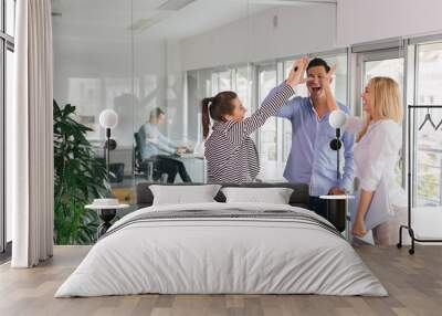 Group of business professionals giving each other a high-five  Wall mural