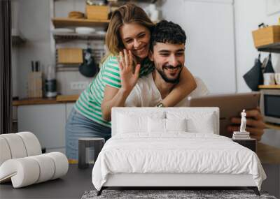 Happy couple talk on the video call Wall mural