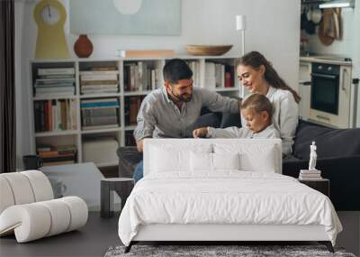 happy family spending time together using tablet computer at home Wall mural