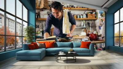 man preparing food in his kitchen Wall mural