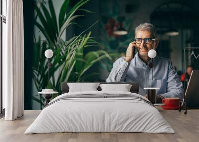 man talking on the mobile phone in cafe bar. Wall mural