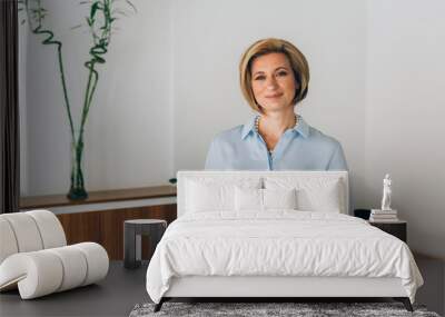 mid aged businesswoman posing in her office Wall mural