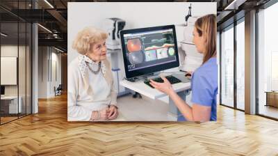 older woman has eye examination. digital retina scanner Wall mural